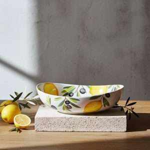 Italian handcrafted ceramics with lemon and olive decoration on a white background