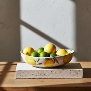 details of handcrafted Italian ceramics in lemon, olive and cedar on a white background