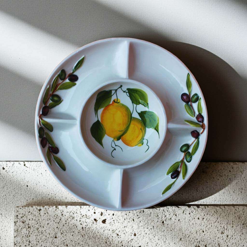 ceramic appetizer tray decorated with lemons and olives on a white background, suitable for all kinds of appetizers