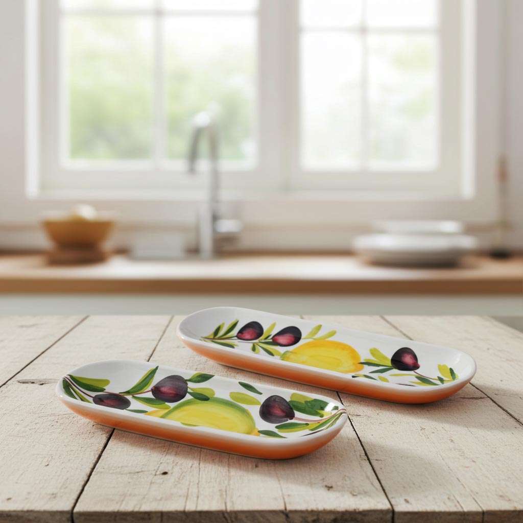 ceramic boat-shaped container with lemon and olive design on a white background