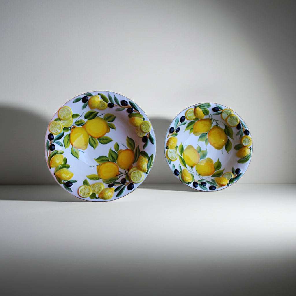 ceramic bowl decorated with lemons and olives on a white background