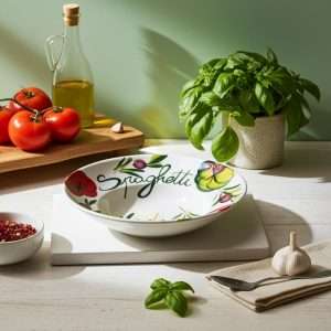 hand-decorated priest's hat plate with tomatoes and olives on white background