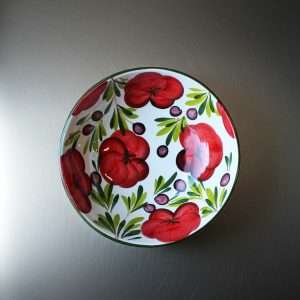 white ceramic bowl with tomato and olive design on a white background