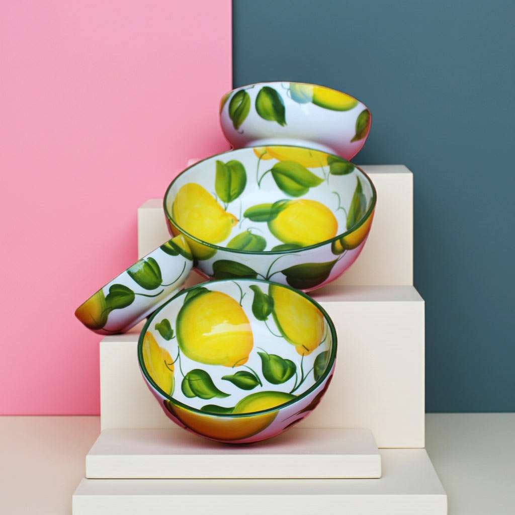 set of kitchen bowls decorated with lemons and leaves on a white background