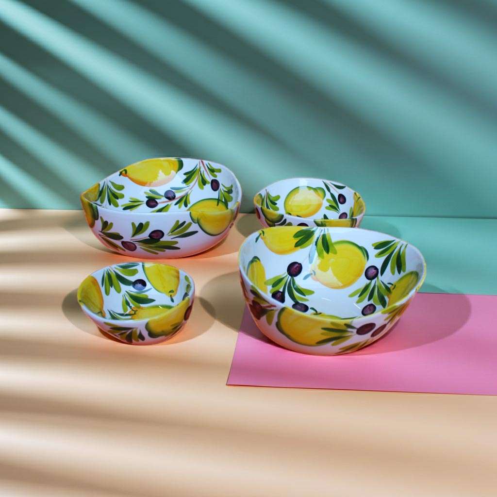 details of handmade ceramic containers in various sizes with lemon and olive design on a white background