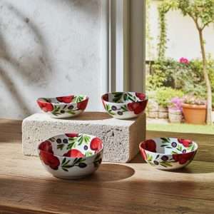details of Italian ceramic bowls in various sizes decorated with tomato and olive design on a white background