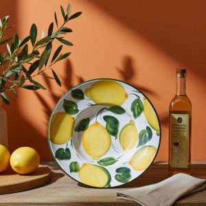details of priest's hat plate in ceramic decorated with lemons and leaves on a white background