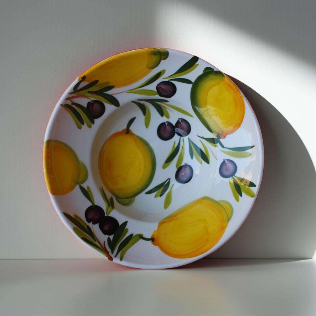 details of cappello da prete plate decorated with lemons and olives on a white background