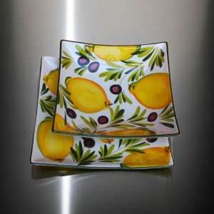 square high-quality ceramic plates decorated with lemons and olives on a white background