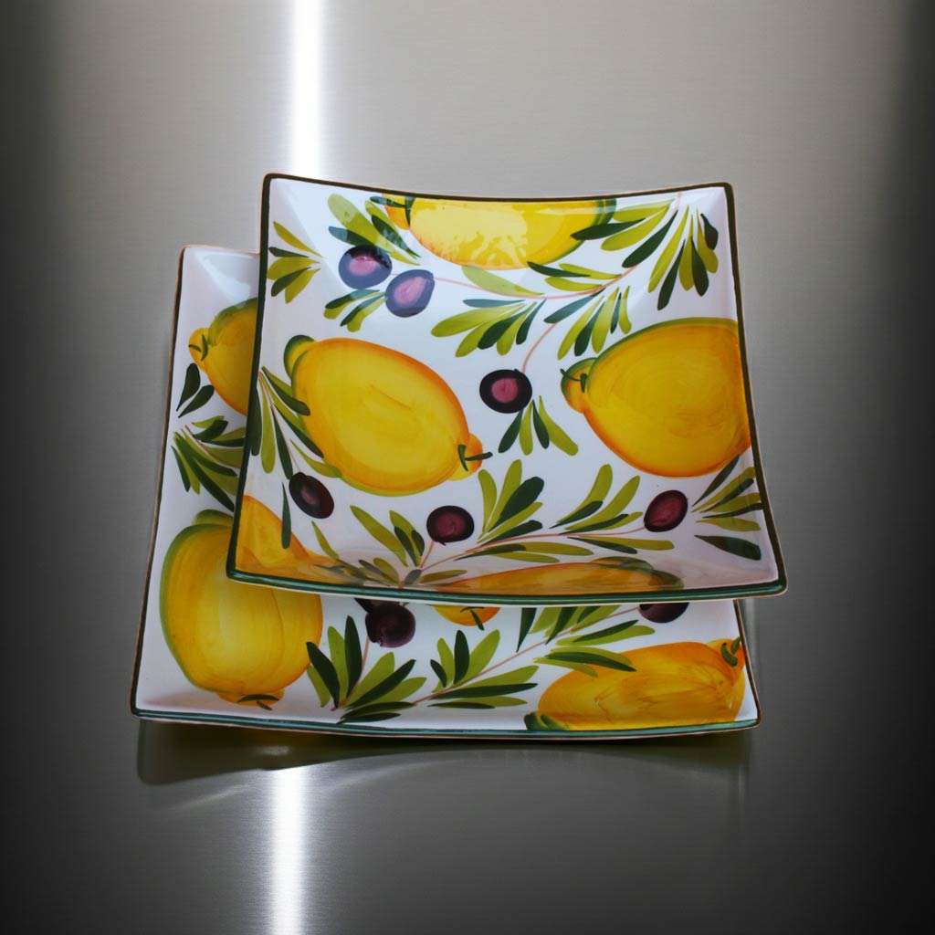 square high-quality ceramic plates decorated with lemons and olives on a white background