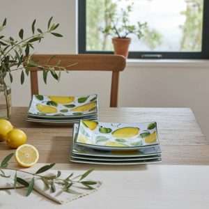 square ceramic plates with lemon and leaf design on a white background