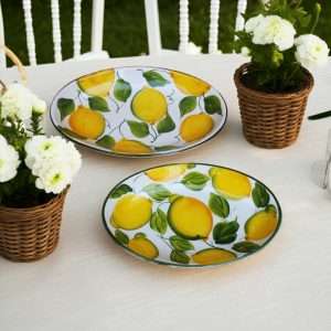 ceramic baking dish with lemon and leaf design on a white background