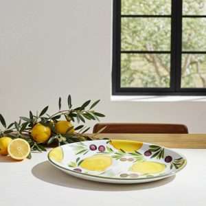 ceramic baking dish with lemon and olive design on a white background