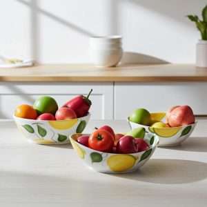 details of handmade ceramic bowl decorated with lemons and leaves on a white background