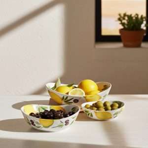 ceramic bowl with lemon and olive decoration on white background