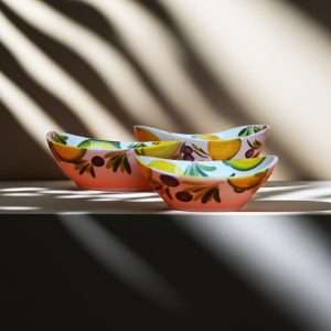 details of ceramic bowl with lemon and olive decoration on white background