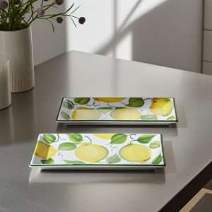 details of rectangular ceramic trays with lemon and leaf decor on a white background
