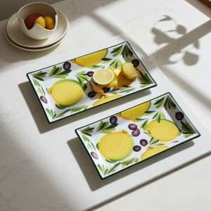 ceramic tray decorated with lemons and olives on a white background