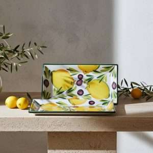 details of ceramic tray decorated with lemons and olive on white background