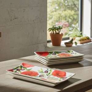 ceramic trays with tomato and olive decoration on white background