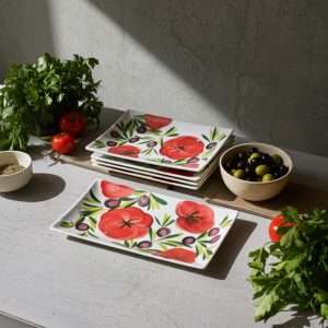 ceramic trays with tomato and olive decoration on white background