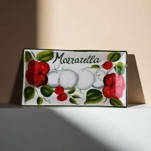 rectangular tray decorated with tomato and mozzarella on a white background
