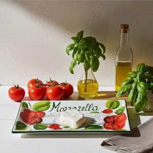 rectangular tray decorated with tomato and mozzarella on a white background