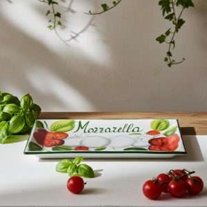 rectangular tray decorated with tomato and mozzarella on a white background