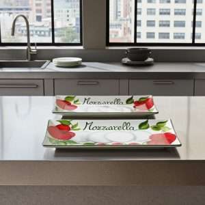 rectangular white ceramic trays decorated with tomato and mozzarella design on a white background