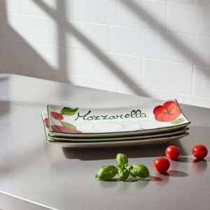 details of rectangular white ceramic trays decorated with tomato and mozzarella