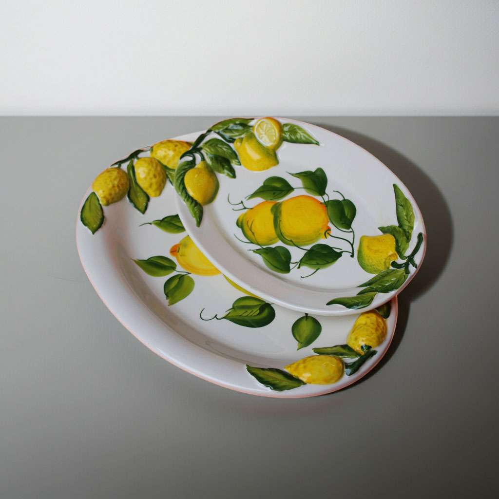 Details of the decorative tray with lemons and leaves on a white background