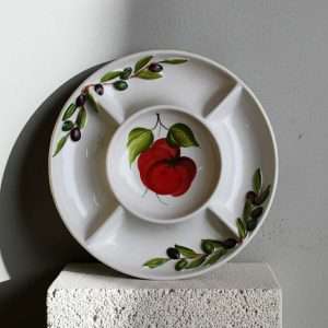 handcrafted appetizer tray with tomato and olive design on a white background