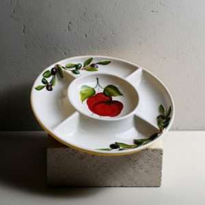 handcrafted appetizer tray with tomato and olive design on a white background
