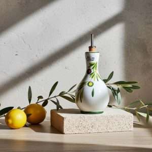 Details of the ceramic oil bottle with various designs on a white background