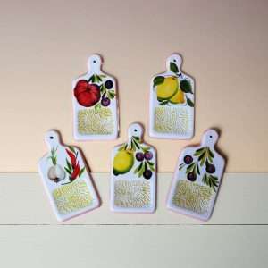 Details of white ceramic garlic graters with various designs on a white background