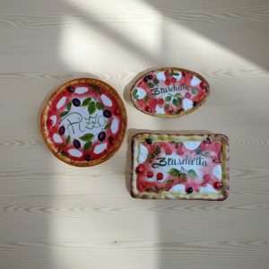details of a pizza plate and bruschetta plate decorated with tomato and mozzarella design
