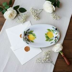 small appetizer tray with lemon and olive design on a white background