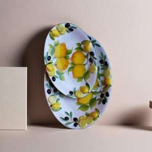Decorated ceramic tray with lemon and olive motifs on a white background