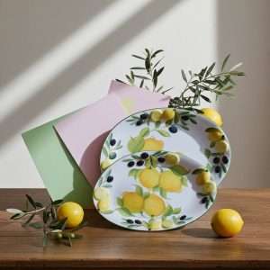 Set of decorated ceramic trays with lemon and olive motifs on a white background