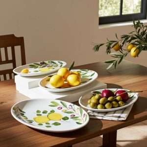 Serving tray set with lemon and olive decor on a white background