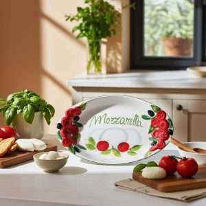 handcrafted ceramic tray with embossed tomato decorations and a central mozzarella design on a white background