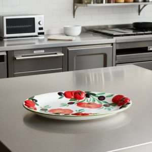 handcrafted ceramic tray, hand-decorated with tomato and olive design on a white background